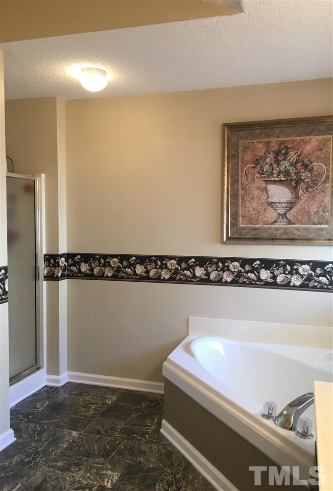 169 South Ridge Drive Garner, NC 27529 - Photo 14 of 20 a bathroom with a bathtub and a window