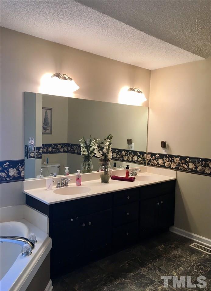 169 South Ridge Drive Garner, NC 27529 - Photo 15 of 20 a bathroom with a double vanity sink and a mirror