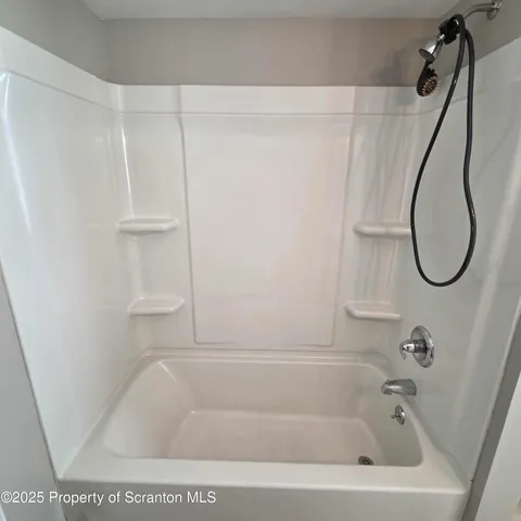 a bathroom with a bath tub and a shower