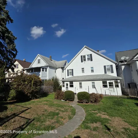 a view of house with yard and green space