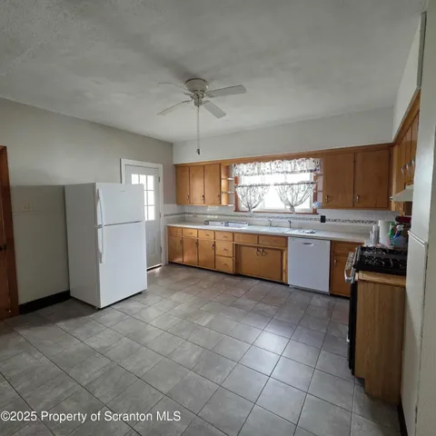 a large kitchen with cabinets and stainless steel appliances
