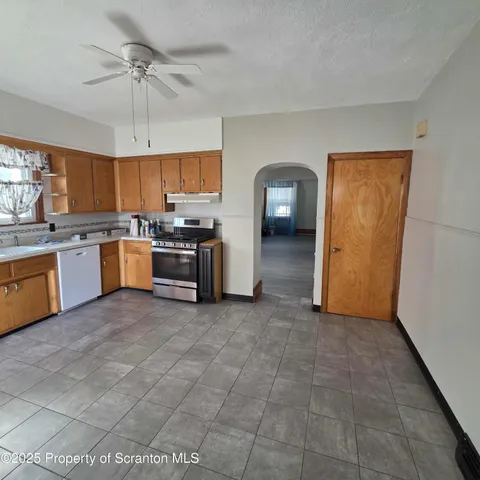 a kitchen with stainless steel appliances granite countertop a stove and a sink