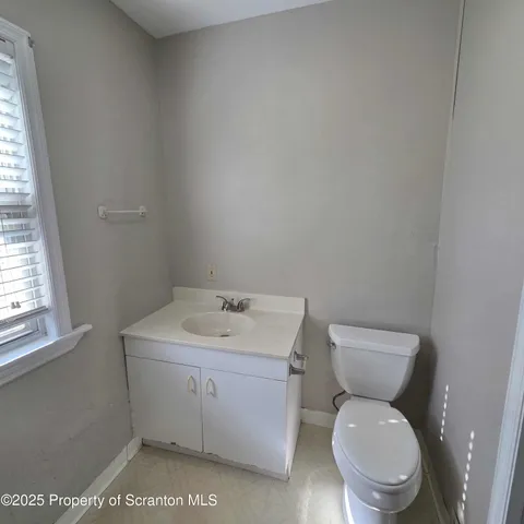a white toilet sitting next to a bathroom sink