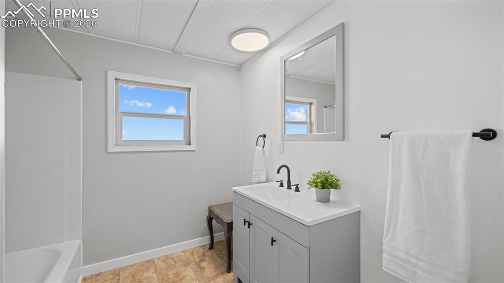 37155 East Jones Road Yoder, CO 80864 - Photo 27 of 50 a bathroom with a sink a mirror and a shower