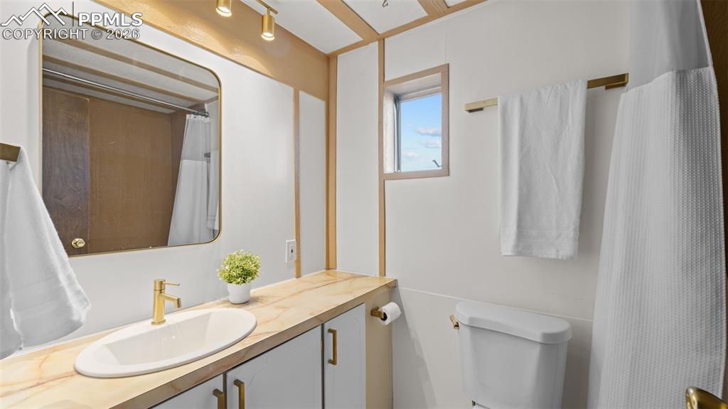 37155 East Jones Road Yoder, CO 80864 - Photo 35 of 50 a bathroom with a sink vanity and a mirror