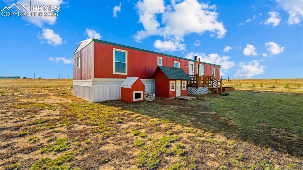 37155 East Jones Road Yoder, CO 80864 - Photo 8 of 50 a view of a house with backyard porch and patio