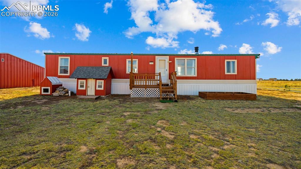 37155 East Jones Road Yoder, CO 80864 - Photo 9 of 50 a backyard of a house with barbeque oven table and chairs