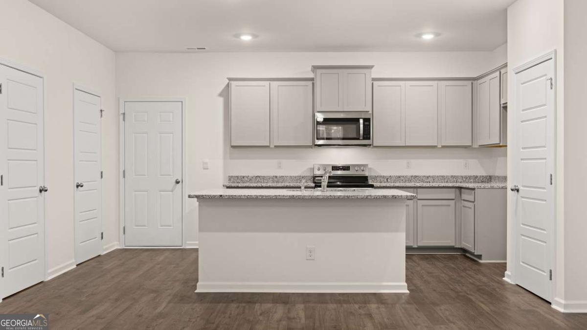 360 Sound Circle Stockbridge, GA 30281 - Photo 11 of 47 a kitchen with stainless steel appliances granite countertop a stove a sink and a refrigerator