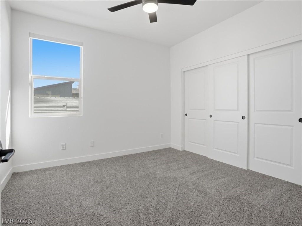 9725 Starlight Ridge Avenue Las Vegas, NV 89148 - Photo 33 of 47 This bright and airy bedroom features soft carpeting, ample natural light, and convenient closet access.