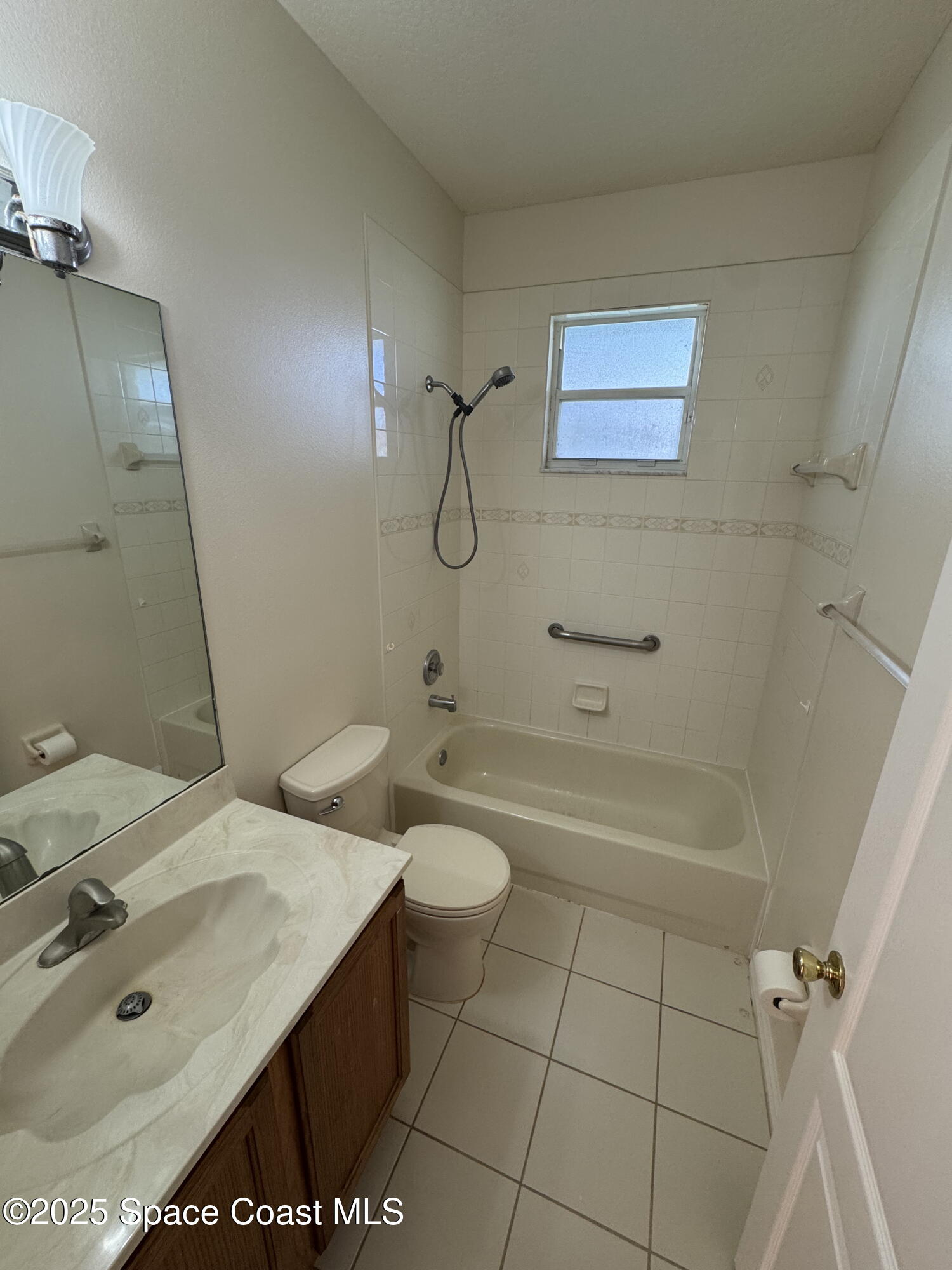 1522 Breese Street Northeast Palm Bay, FL 32905 - Photo 11 of 12 a bathroom with a sink a toilet and shower