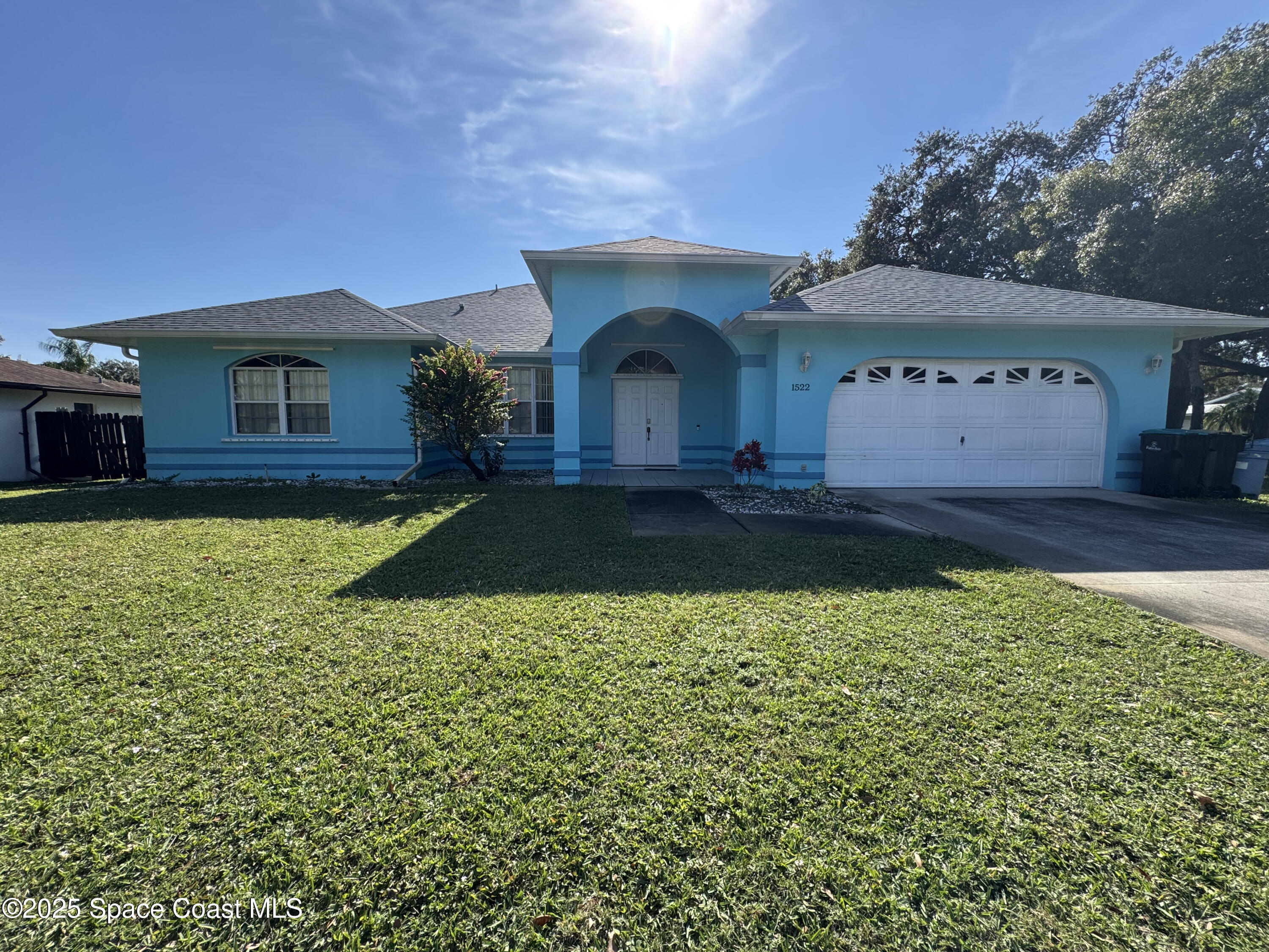 1522 Breese Street Northeast Palm Bay, FL 32905 - Photo 2 of 12 a view of a house with a yard