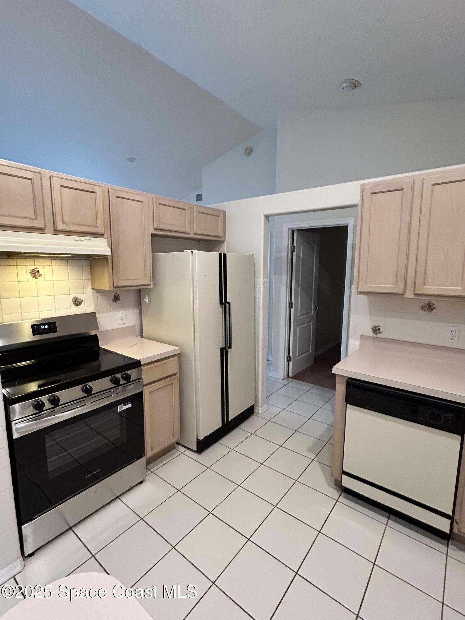 1522 Breese Street Northeast Palm Bay, FL 32905 - Photo 9 of 12 a kitchen with a stove a sink and a refrigerator