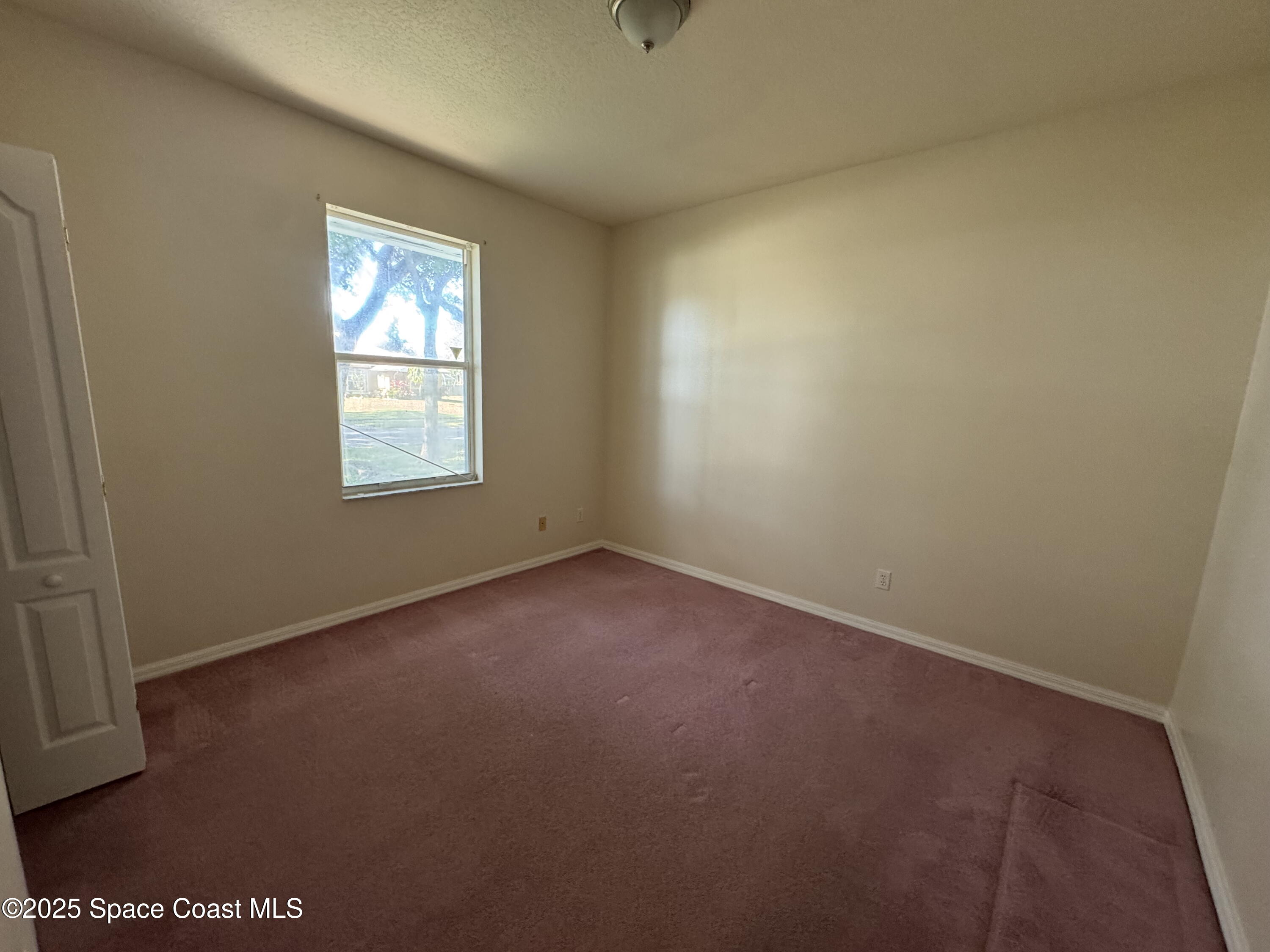 1522 Breese Street Northeast Palm Bay, FL 32905 - Photo 10 of 12 an empty room with windows