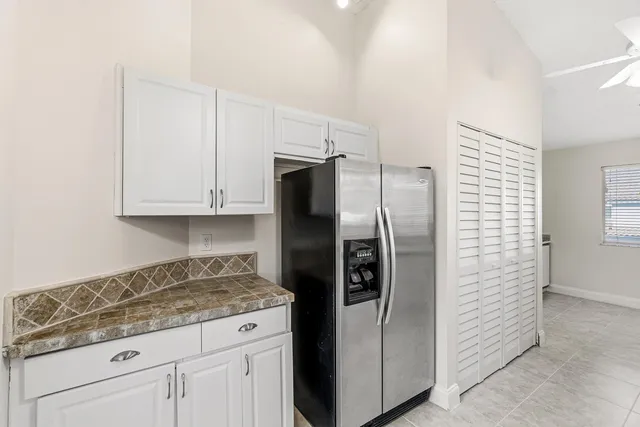 a kitchen with granite countertop a stove a sink and a window