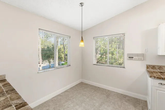 a view of an entryway with wooden floor and a bathroom