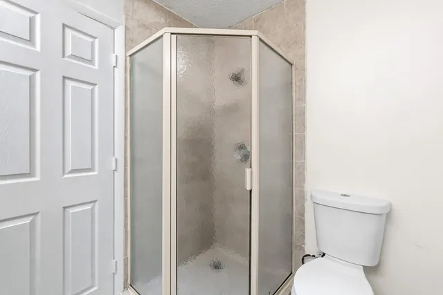 a white toilet sitting next to a bath tub