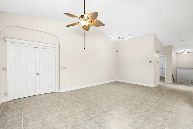 a view of a hallway with an entryway and chandelier