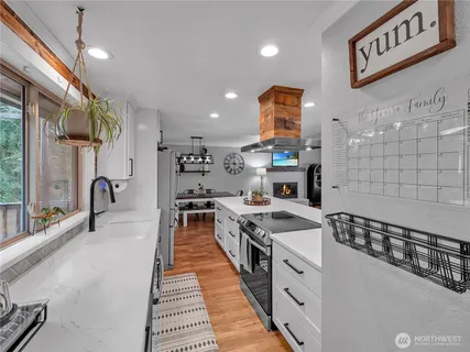 a kitchen with stainless steel appliances a sink stove top oven and cabinets