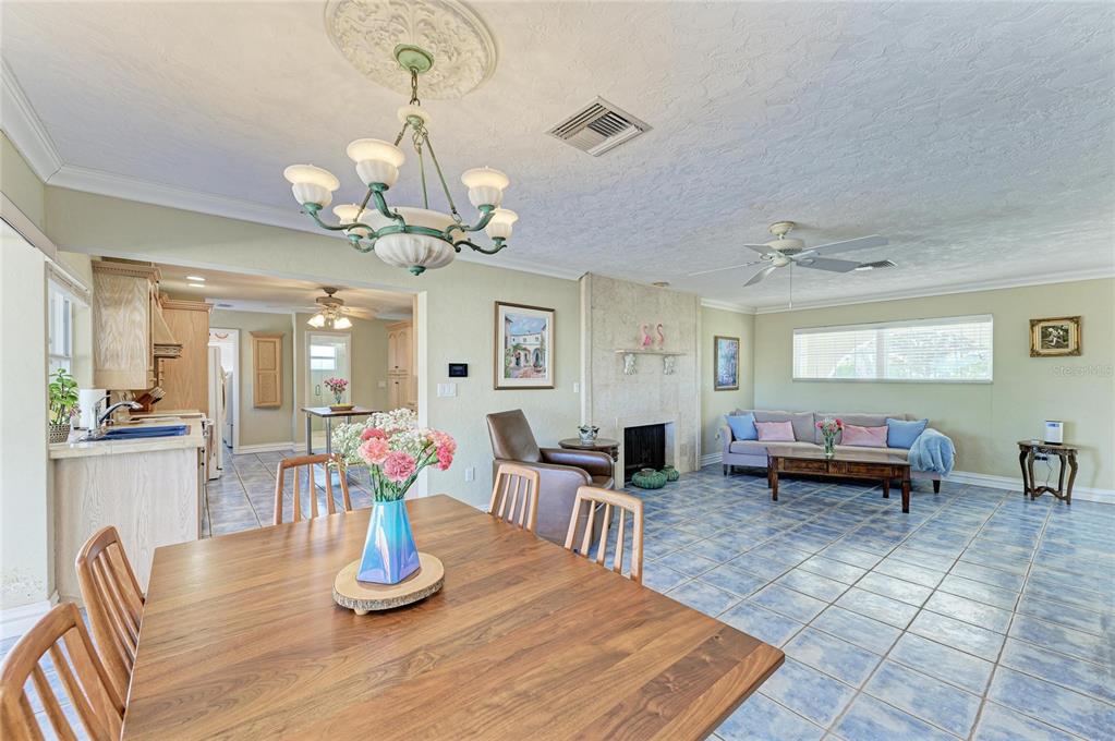 612 Bayshore Road Nokomis, FL 34275 - Photo 11 of 96 a dining room with wooden floor a chandelier a wooden table and chairs