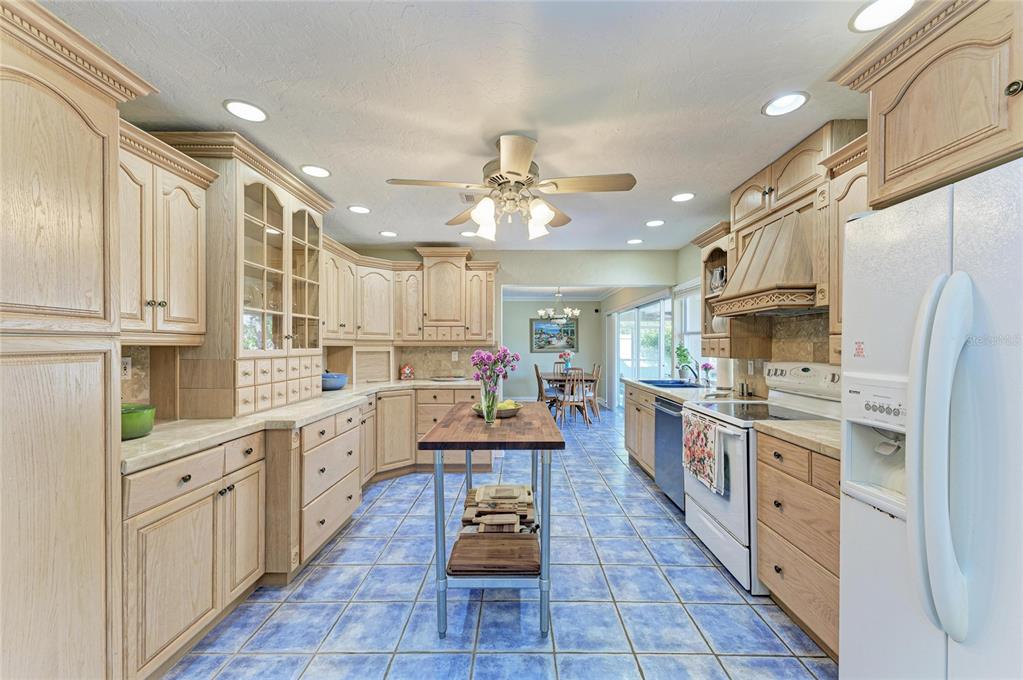 612 Bayshore Road Nokomis, FL 34275 - Photo 12 of 96 a large kitchen with stainless steel appliances lots of counter space and wooden floors