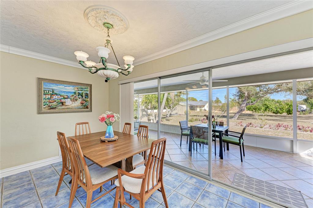 612 Bayshore Road Nokomis, FL 34275 - Photo 18 of 96 a dining room with furniture a chandelier and wooden floor