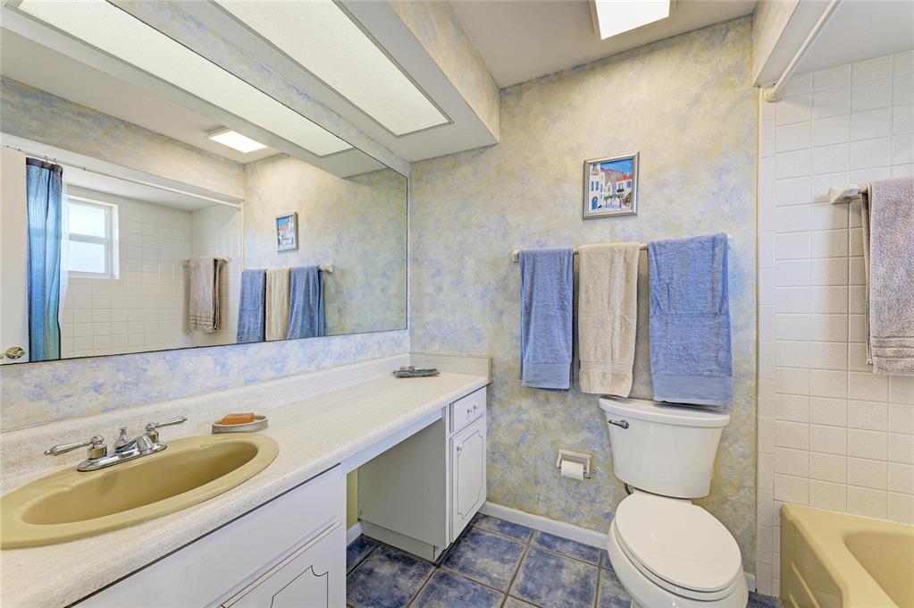 612 Bayshore Road Nokomis, FL 34275 - Photo 27 of 96 a bathroom with a granite countertop toilet sink and mirror