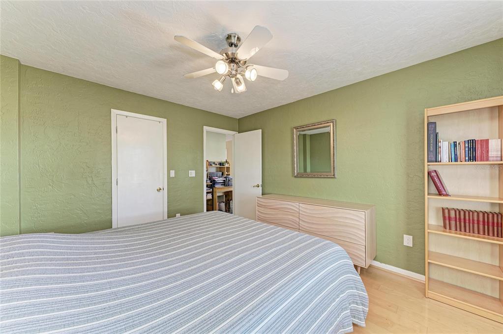 612 Bayshore Road Nokomis, FL 34275 - Photo 30 of 96 a bedroom with a bed and a chandelier