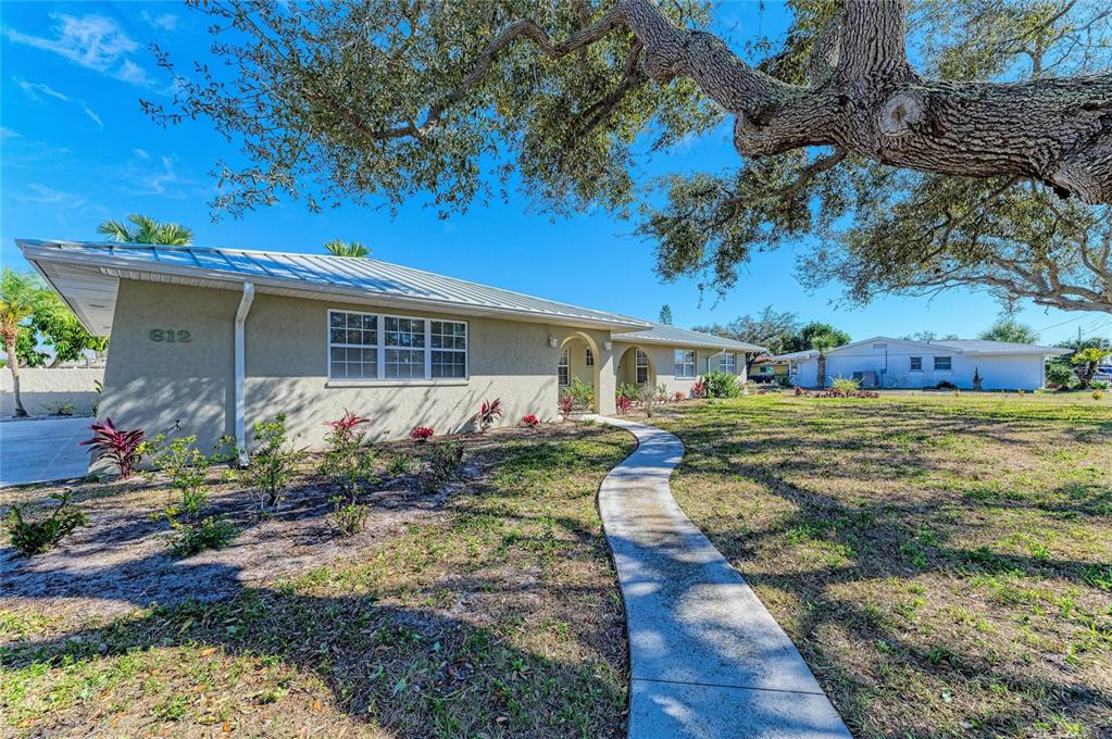 612 Bayshore Road Nokomis, FL 34275 - Photo 5 of 96 a front view of a house with garden