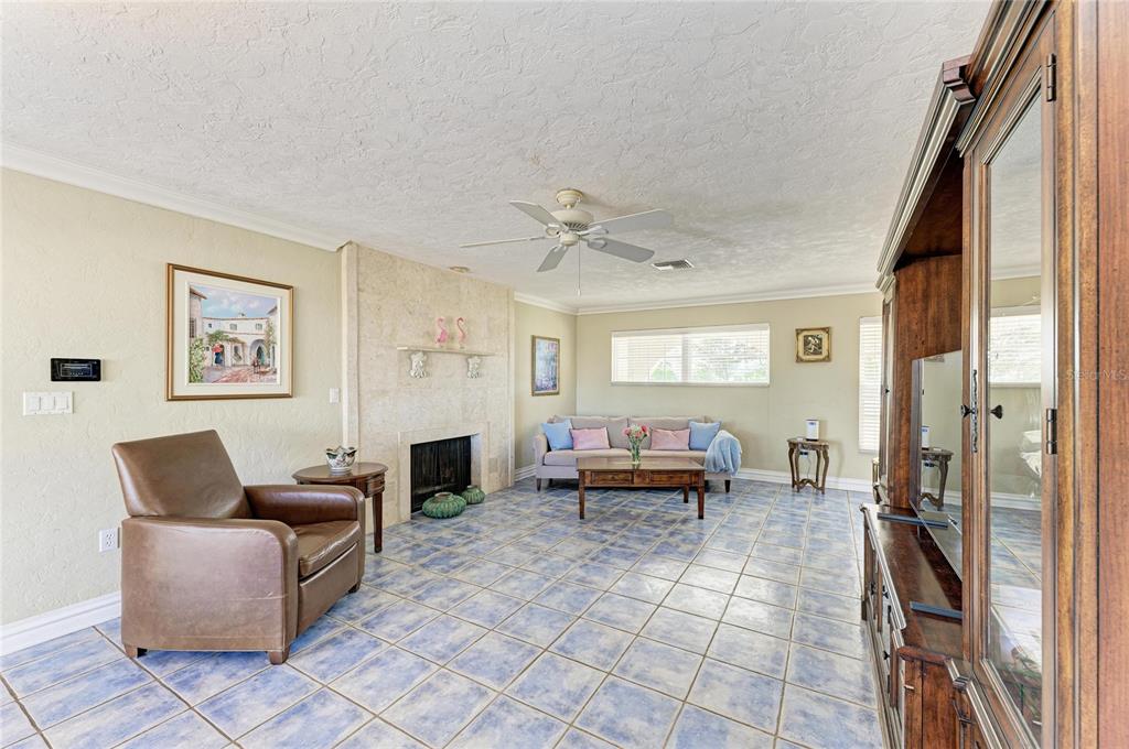 612 Bayshore Road Nokomis, FL 34275 - Photo 9 of 96 a living room with furniture a fireplace and a flat screen tv