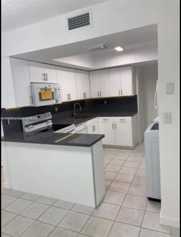 view of bathroom with a toilet sink and mirror