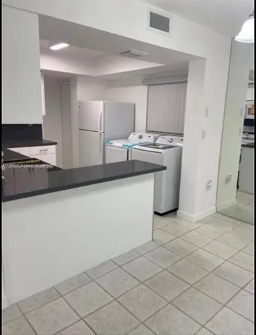 a white toilet sitting next to a bath tub