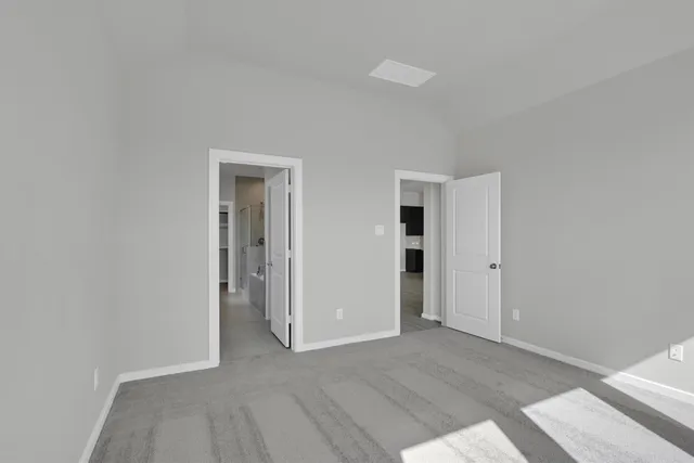 an empty room with closet and a window