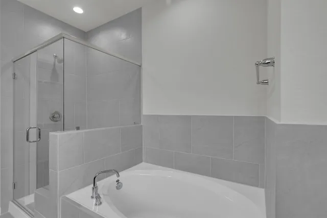 a bathroom with a tub and shower