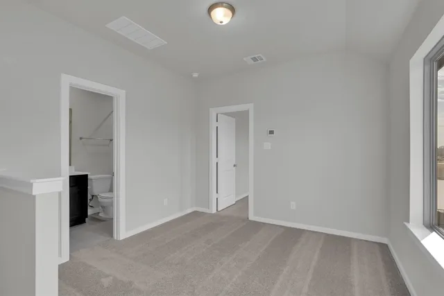 an empty room with closet and windows