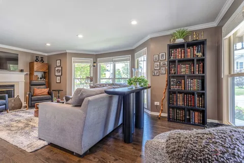 a living room with furniture and a book shelf