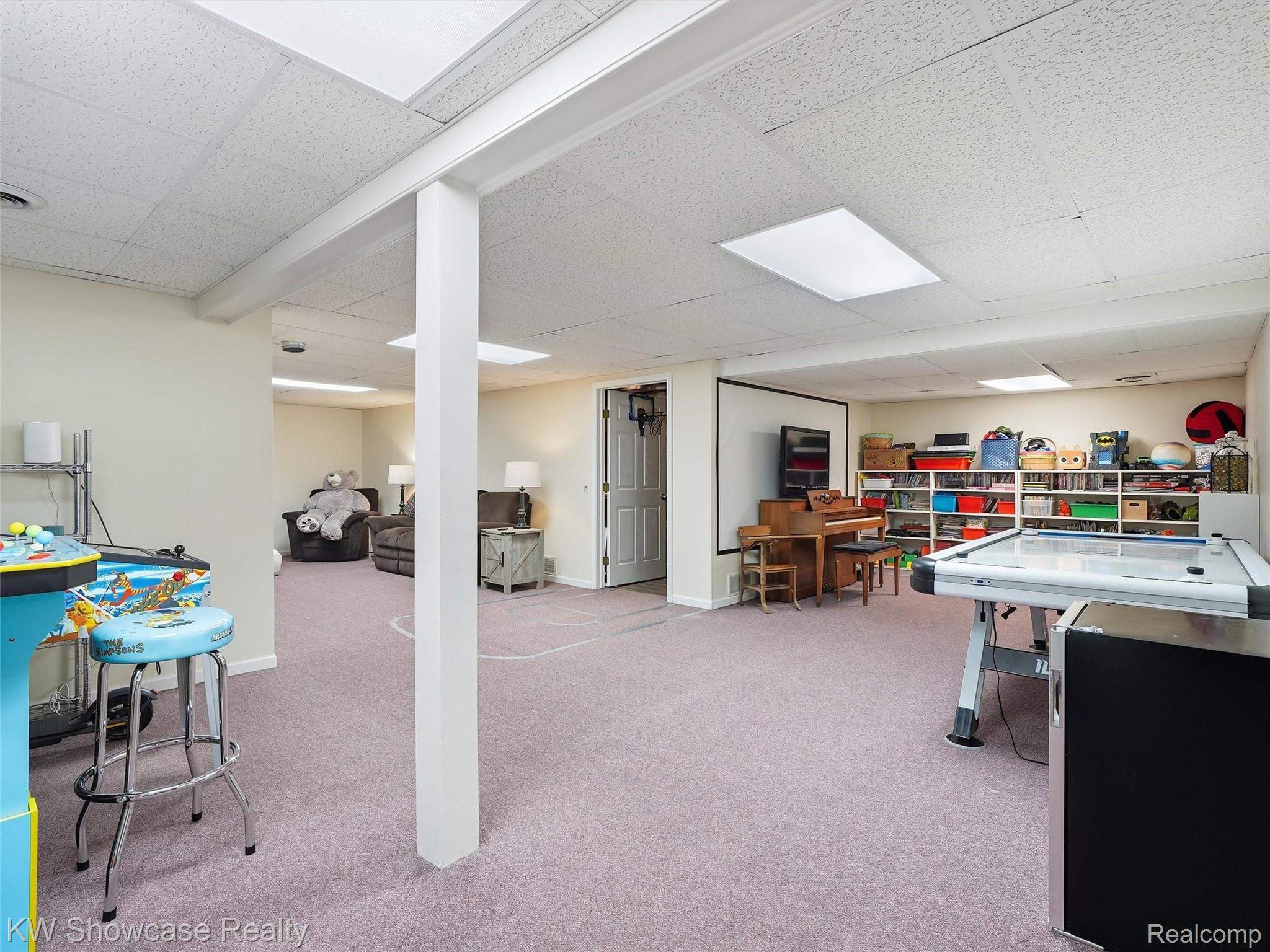 3360 Pleasant Valley Road Brighton, MI 48114 - Photo 37 of 60 Expansive lower-level space featuring light-toned carpeting, recessed lighting, and a drop ceiling