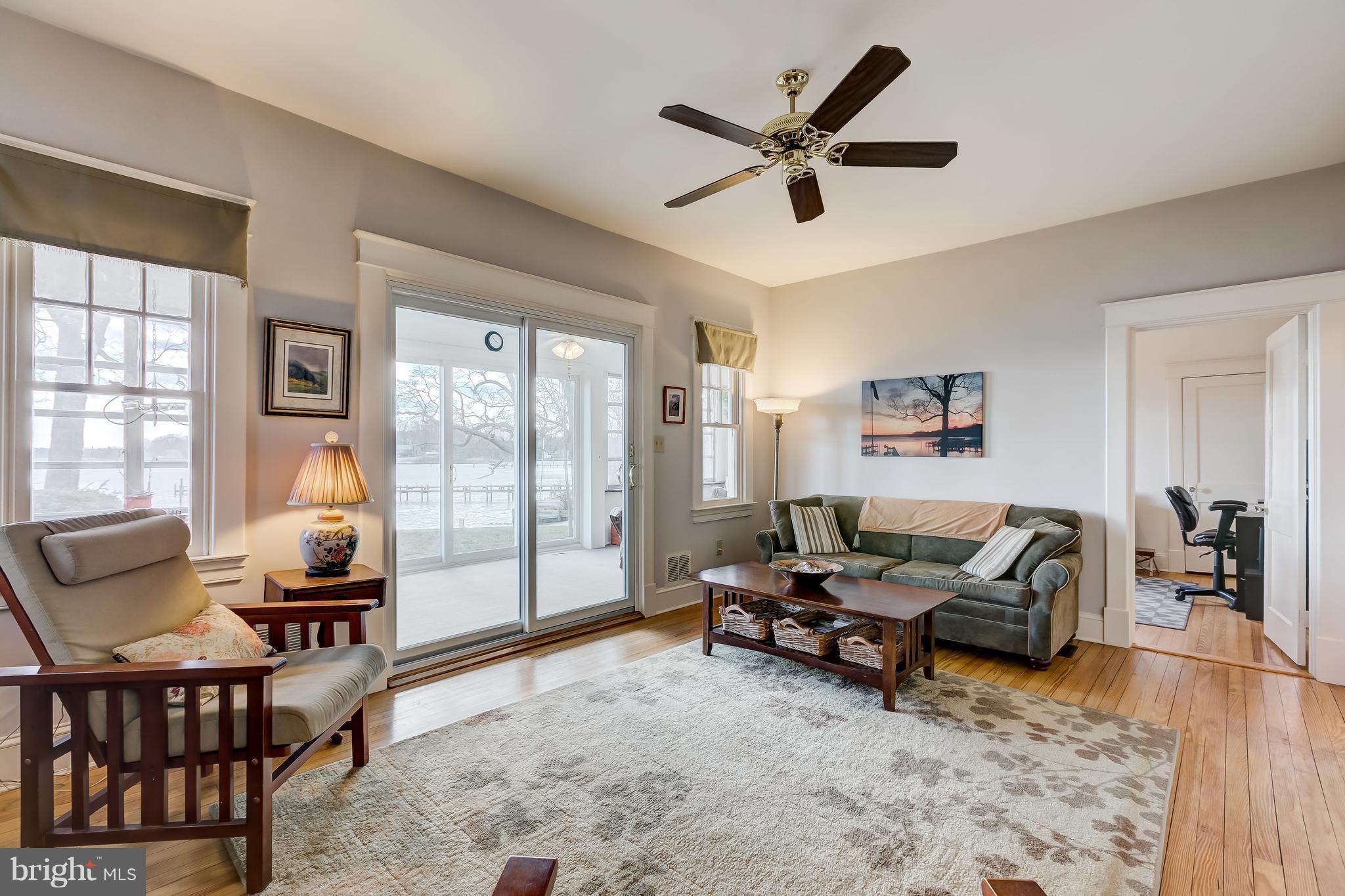 352 Hickory Point Road Pasadena, MD 21122 - Photo 21 of 28 Spacious living area opens to all season sunroom