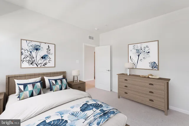 a bedroom with a bed and painting on the wall