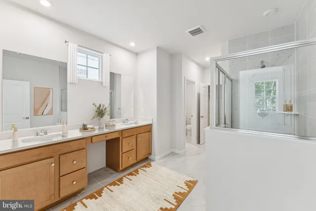 a spacious bathroom with a double vanity sink and a mirror