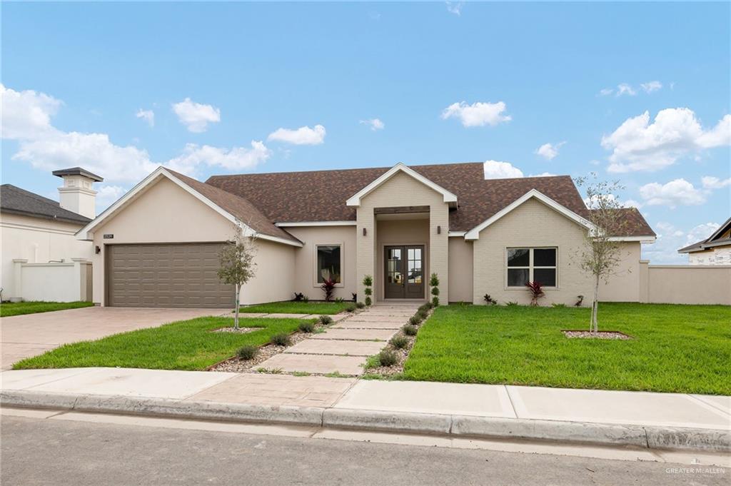 2529 Trinity Avenue McAllen, TX 78504 - Photo 1 of 25 a front view of a house with a yard and garage