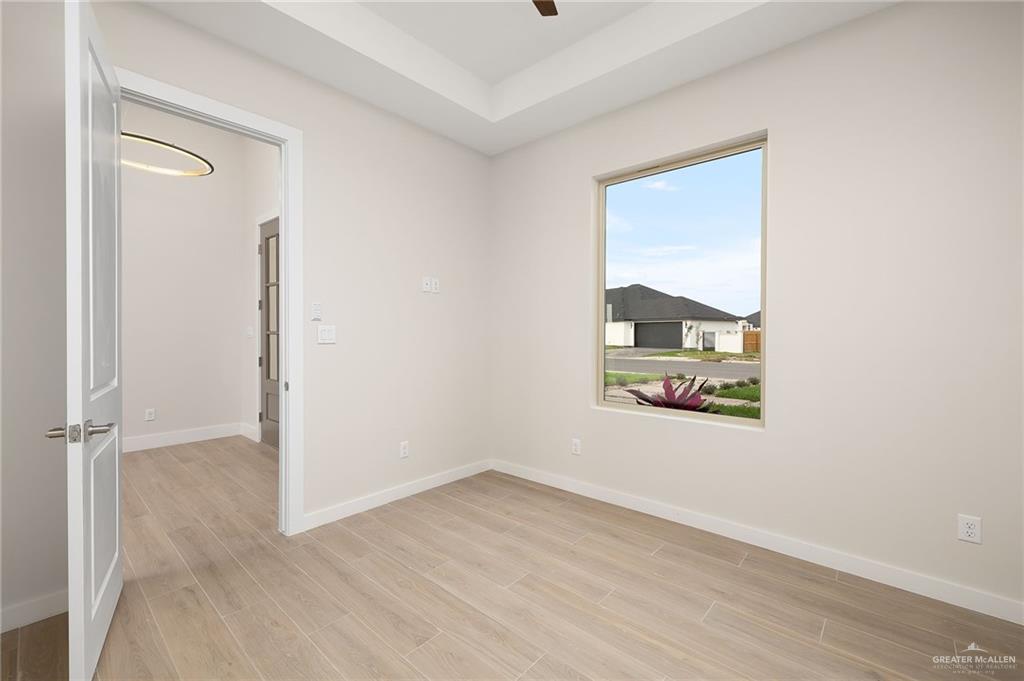 2529 Trinity Avenue McAllen, TX 78504 - Photo 12 of 25 an empty room with a window and wooden floor