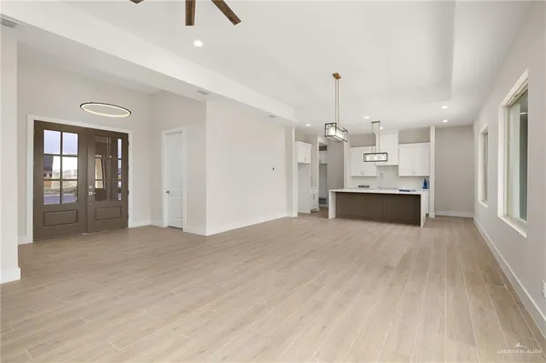 a view of kitchen and hall with wooden floor