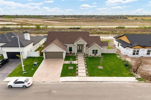 an aerial view of multiple houses with yard