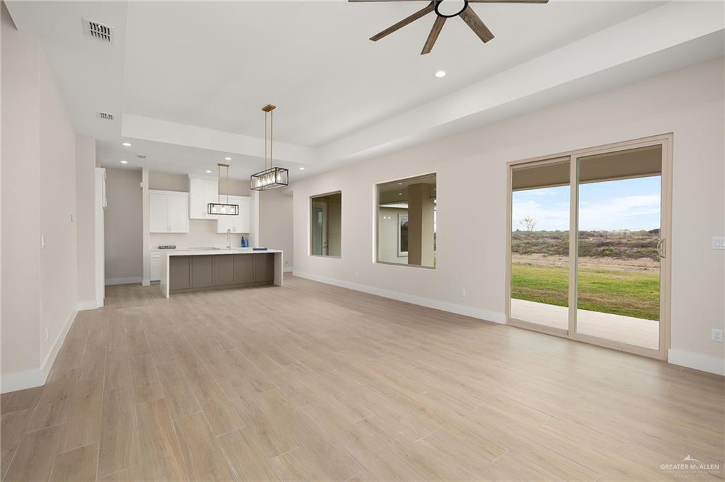 2529 Trinity Avenue McAllen, TX 78504 - Photo 4 of 25 a view of an empty room with a window and kitchen view