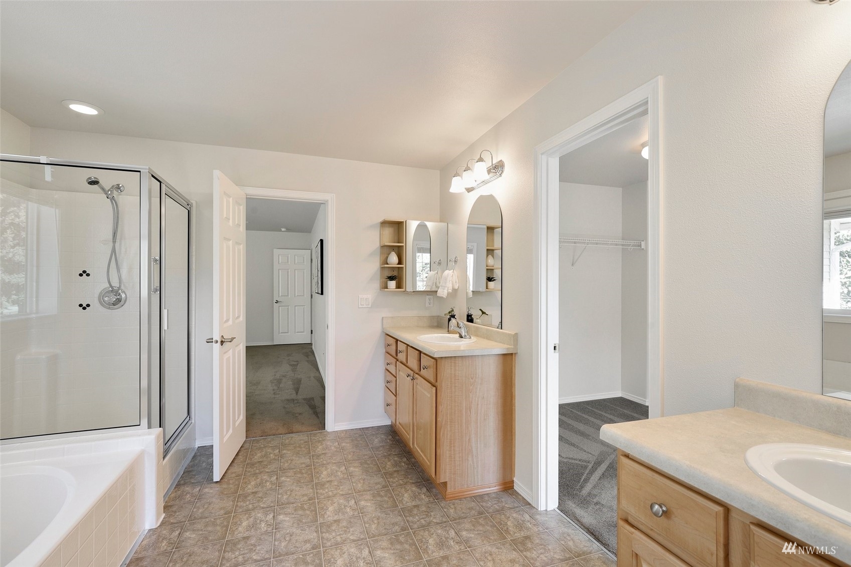 18015 168th Way Southeast Renton, WA 98058 - Photo 22 of 40 a bathroom with a sink a mirror and a bathtub