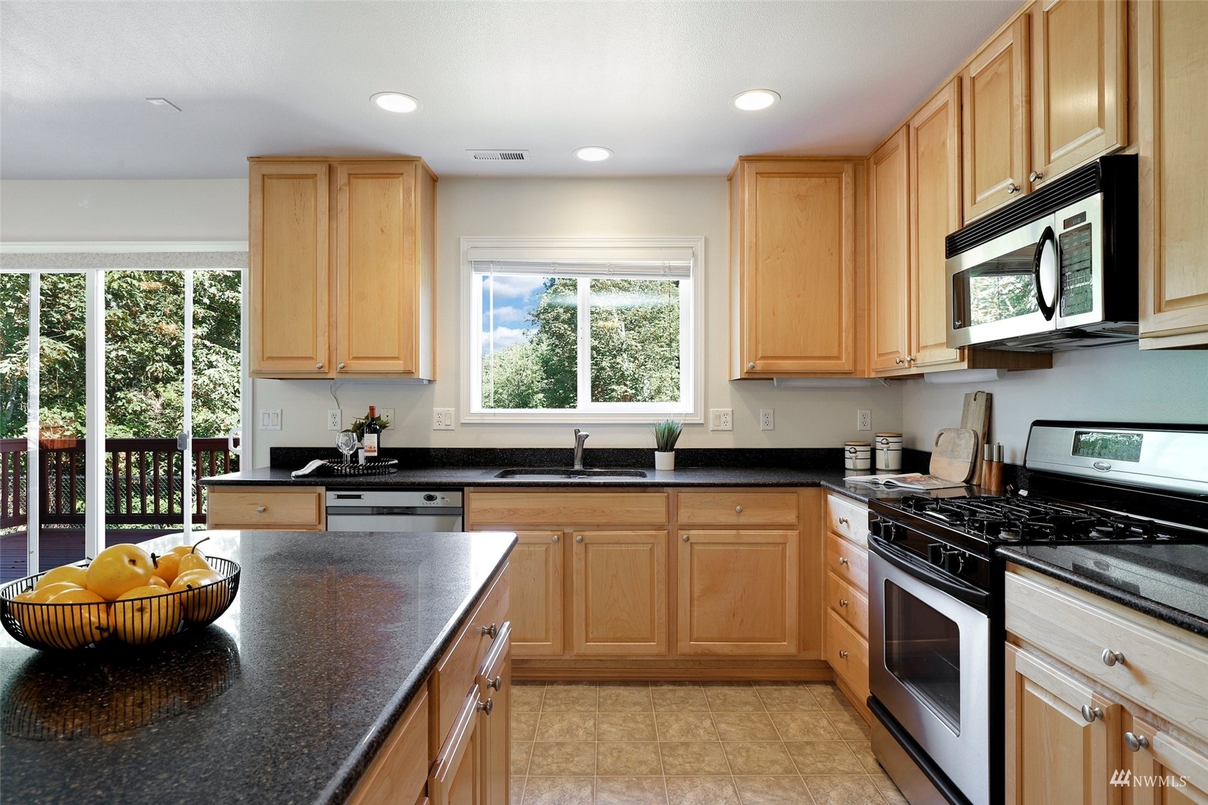 18015 168th Way Southeast Renton, WA 98058 - Photo 6 of 40 a kitchen with stainless steel appliances granite countertop a stove a sink and a microwave
