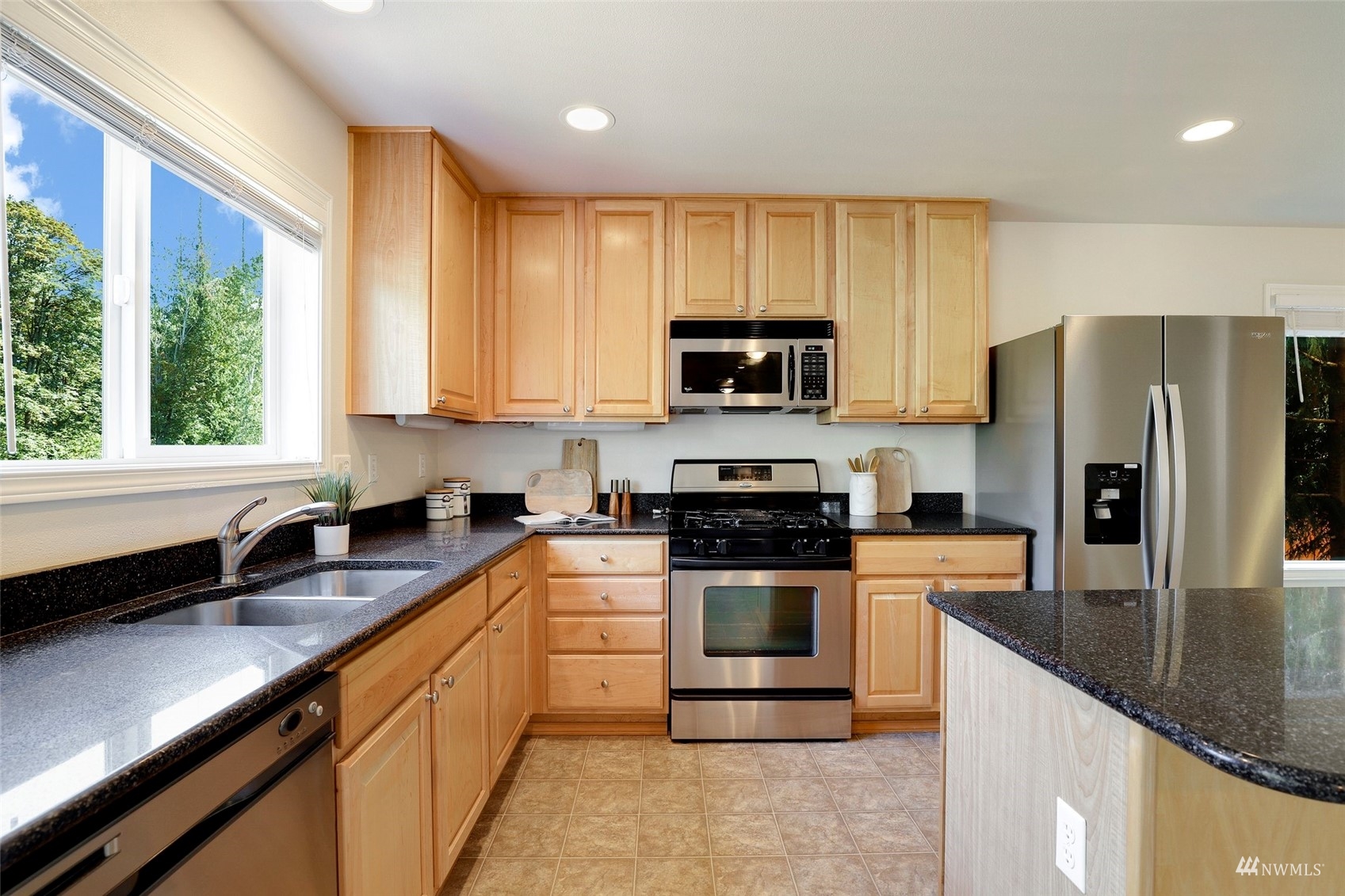 18015 168th Way Southeast Renton, WA 98058 - Photo 7 of 40 a kitchen with stainless steel appliances a stove sink microwave and refrigerator