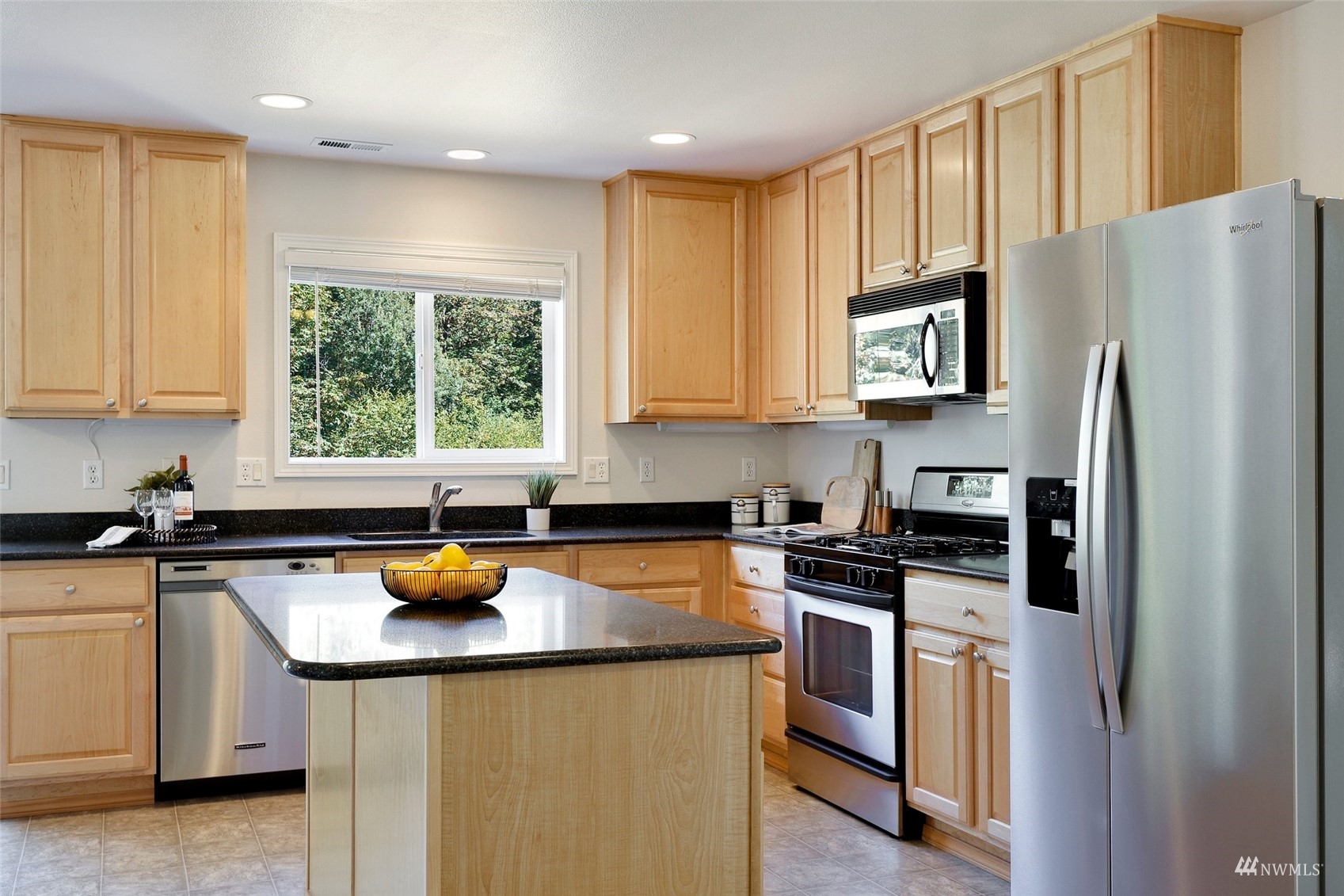 18015 168th Way Southeast Renton, WA 98058 - Photo 8 of 40 a kitchen with stainless steel appliances a stove a sink a refrigerator and cabinets