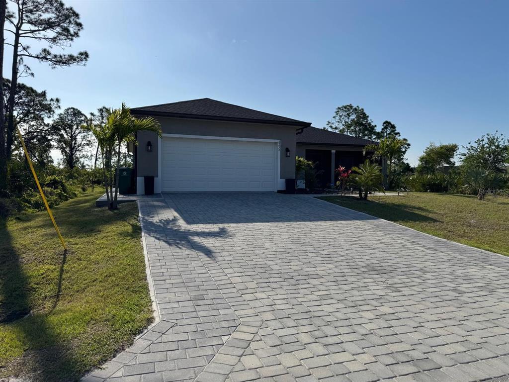 8258 Dimstead Street Port Charlotte, FL 33981 - Photo 1 of 10 a front view of a house with a yard