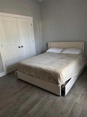 a spacious bedroom with a bed and a table